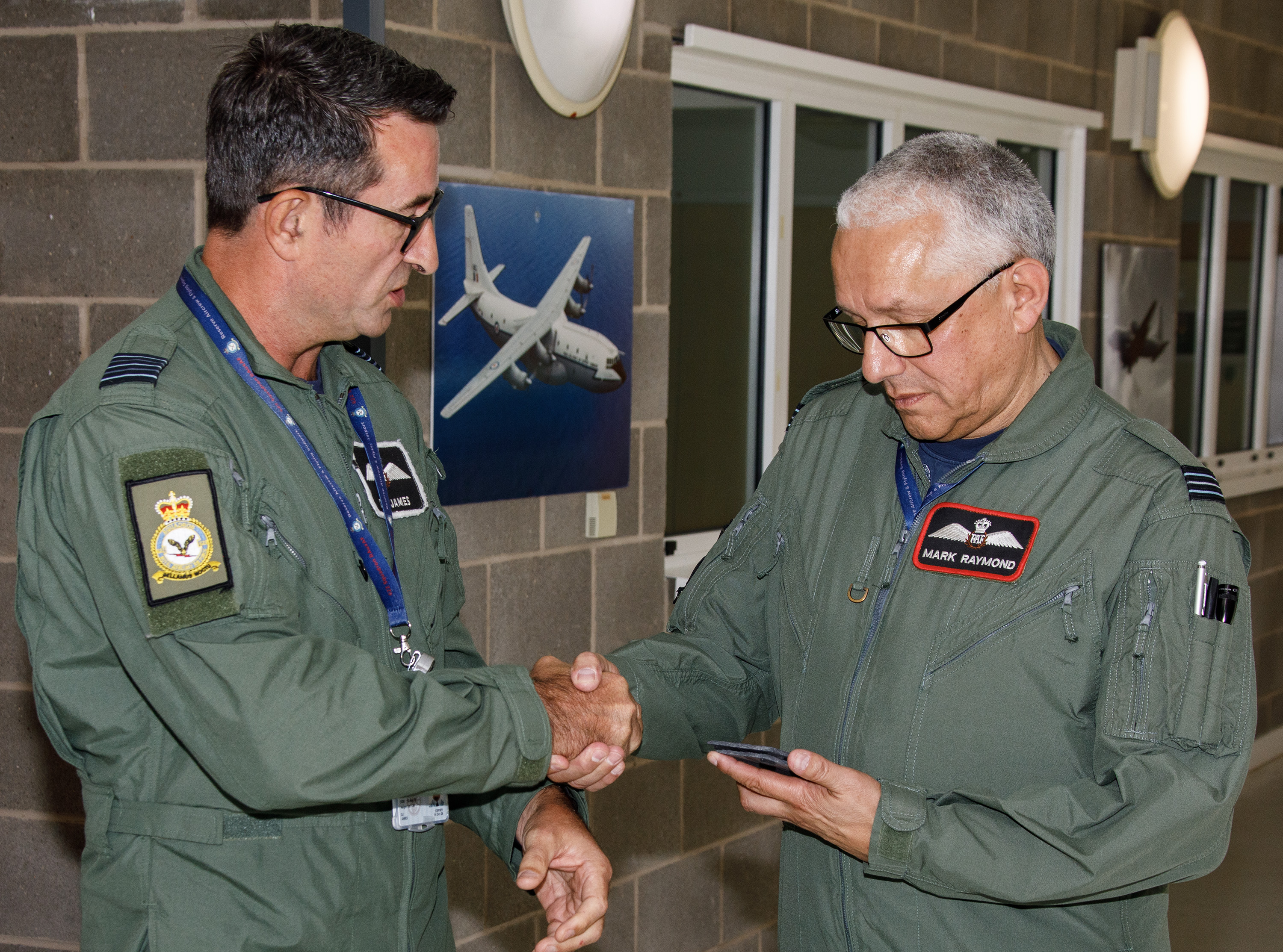 Photo - Wing Commander Dorian James, Officer Commanding 622 Squadron, shakes the hand of Flight Lieutenant Mark Raymond